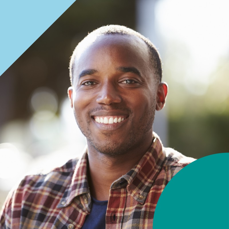 man smiling stood outdoors
